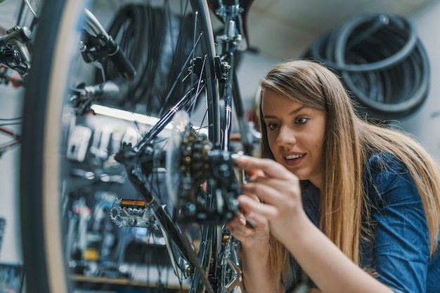 Photo mechanic repairing gears of bicycle