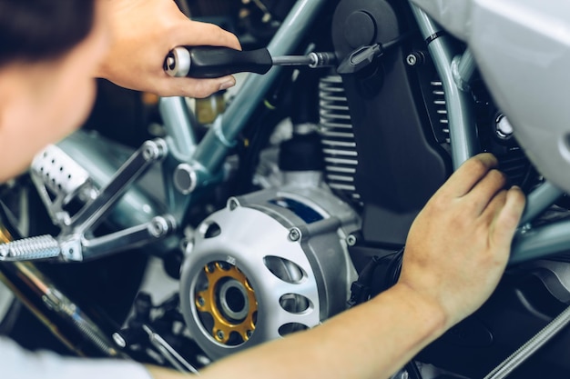 Photo mechanic repairing motorcycle at garage