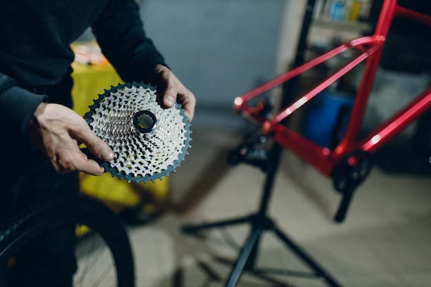 Mechanic repairman assembling custom bicycle in workshop