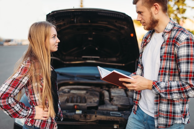 Mechanic shows on broken engine, car breakdown