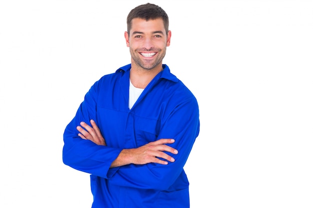 Mechanic standing arms crossed on white background