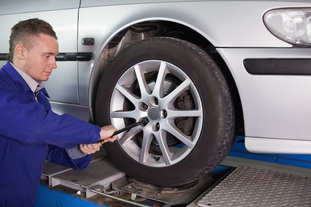 Mechanic unscrewing a bolt