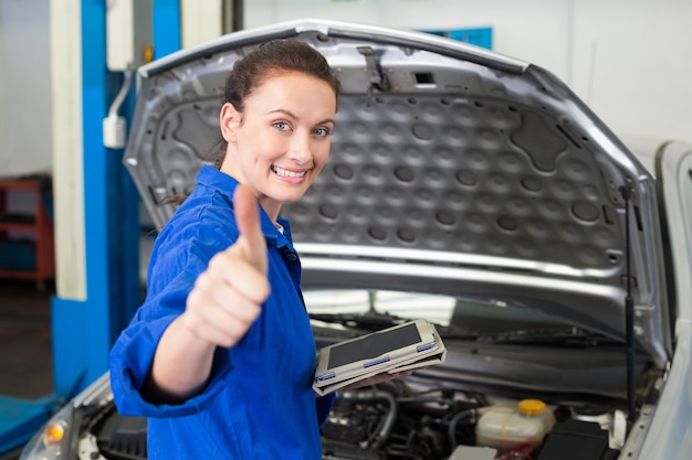 Mechanic using tablet to fix car