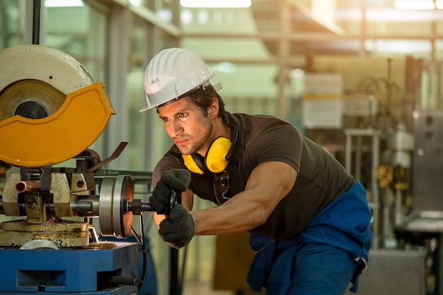 Photo mechanic wearing uniform safety in factory working machine lathe metal, industry concept.