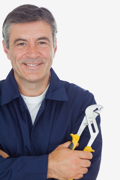 Mechanic with arms crossed holding pliers