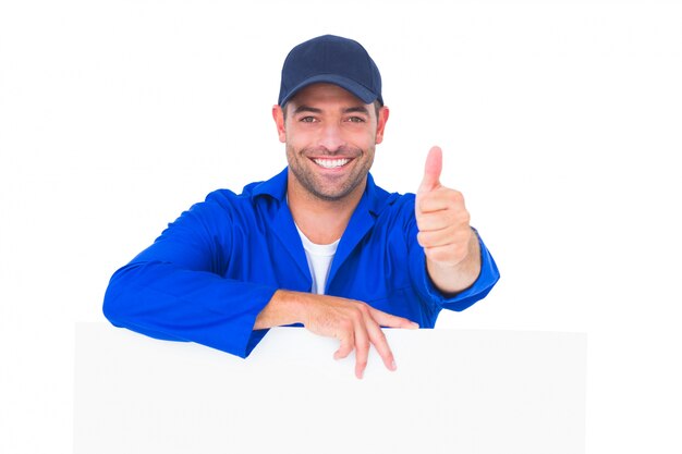 Mechanic with blank placard gesturing thumbs up