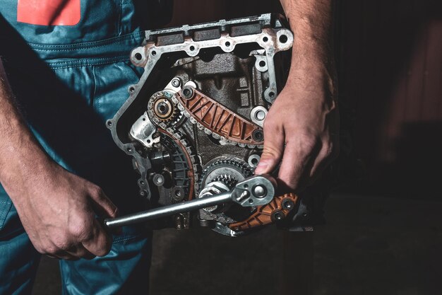 Mechanic with wrench working and repair car engine in car service centre