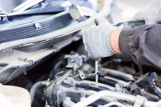 Mechanic working with a car in mechanical workshop