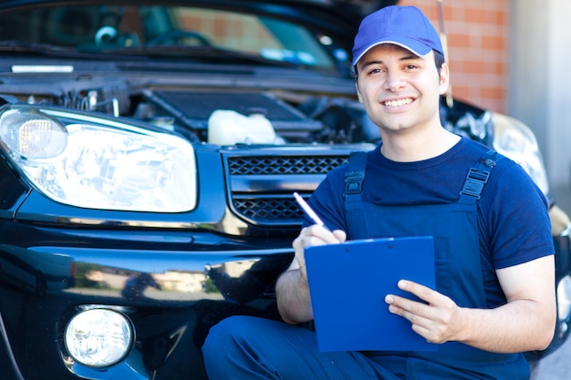 Mechanic writing on a clipboard