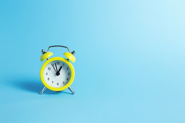 Mechanical alarm clock on the blue background. High quality photo