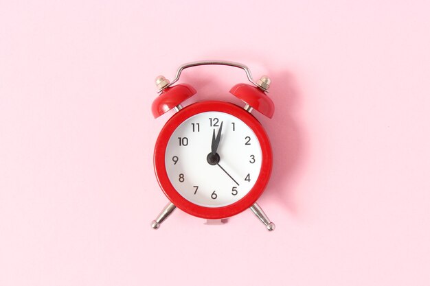 Photo mechanical alarm clock on a colored background