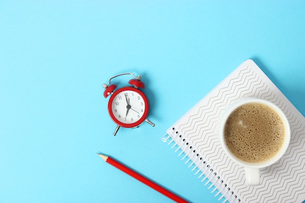 Mechanical alarm clock on a colored background