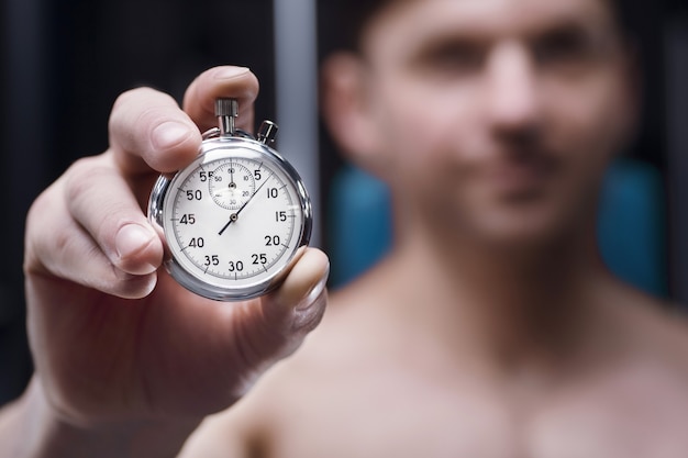 Measuring the Running Speed of an Athlete Using a Mechanical Stopwatch.  Hand with a Stopwatch on the Background of the Legs of a Stock Image -  Image of chronometer, monitor: 257808953