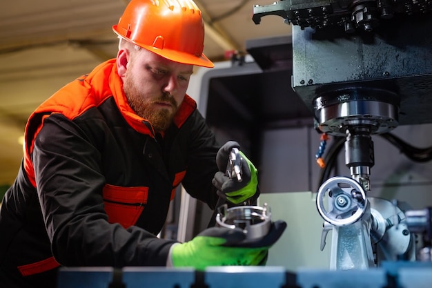 Mechanical technician operative of cnc milling cutting machine center at tool workshop