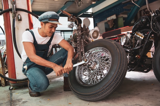 Mechanical technician repair motorbike at workshop