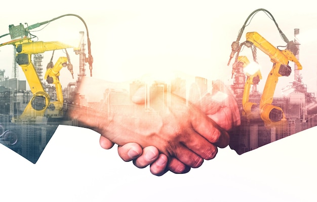 Mechanized industry robot arm and business handshake double exposure