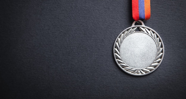 Medal award for winner on black background.