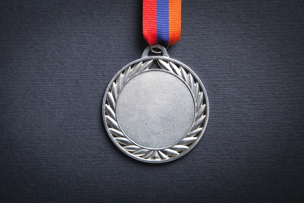 Medal award for winner on black surface.