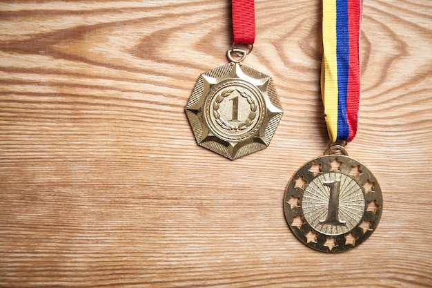 Medals awards for winner on wood background.