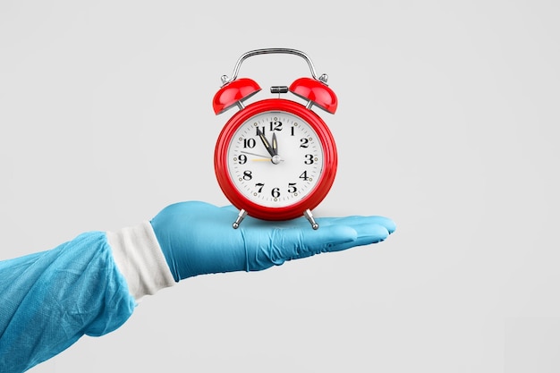 The medic person hand holding alarm clock