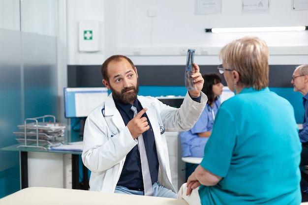 Medic pointing at radiography for osteopathy examination