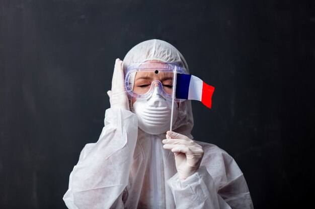 Medic woman wearing protective clothing against the virus with France flag