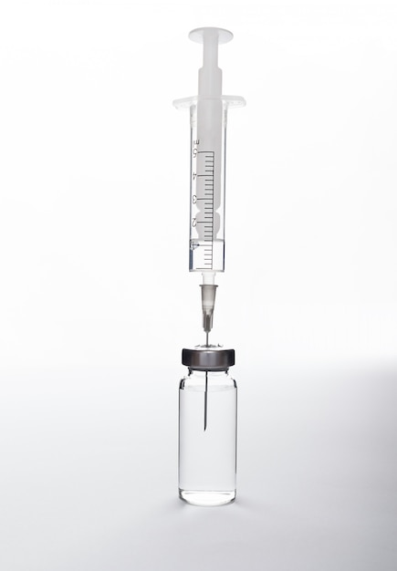 Medical ampoule and syringe on a white and gray background, gradient. Medical product, fever, antivirus, virus