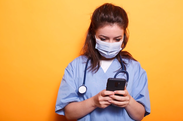 Medical assistant texting on smartphone