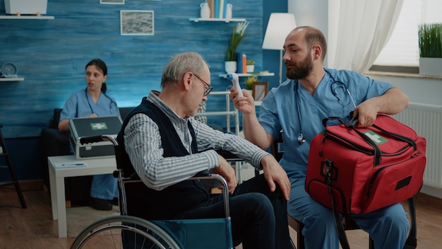 Medical assistant using thermometer for symptoms checkup