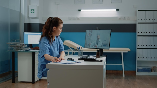 Medical assistant using video call to talk to doctor on
computer about healthcare system. nurse asking medic on online
conference for medical advice with appointment and checkup.