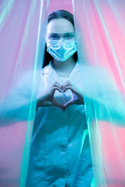 Medical care grateful female doctor heart gesture