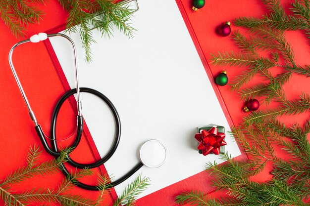 Medical christmas concept with stethoscope blank clipboard with white paper