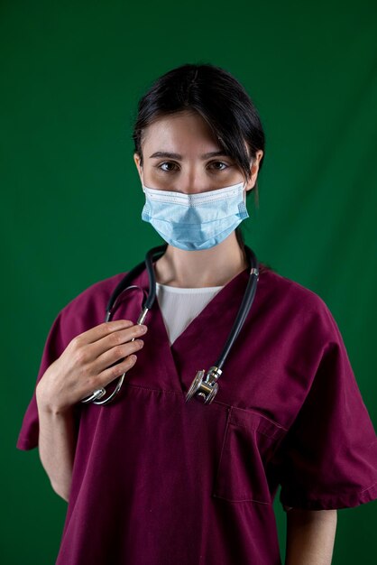 Medical concept of beautiful female doctor in white coat with stethoscope waist up Medical student A hospital worker is looking at the camera and smiling studio plain background