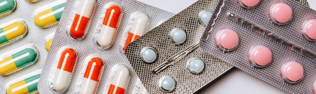 Medical concept flat lay with pills on a blue background