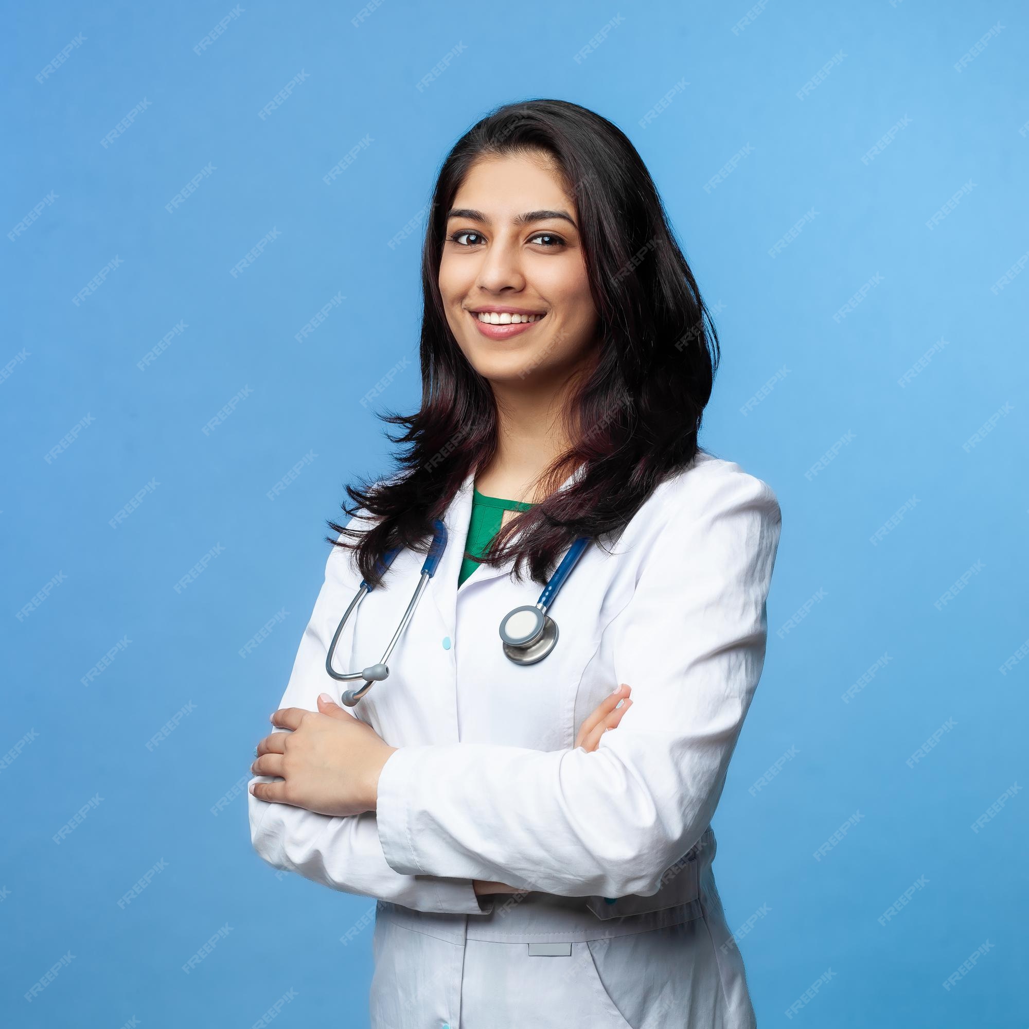 Premium Photo | Medical concept of indian beautiful female doctor in white  coat with stethoscope, waist up. medical student. woman hospital worker  looking at camera and smiling, studio, blue background