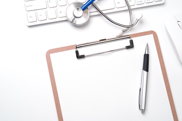 Medical Concept Stethoscope on computer keyboard on white background Physician long term care treatment concept Top view flat lay copy space