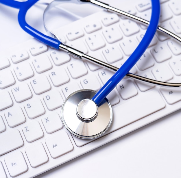 Medical Concept - Stethoscope on computer keyboard on white background