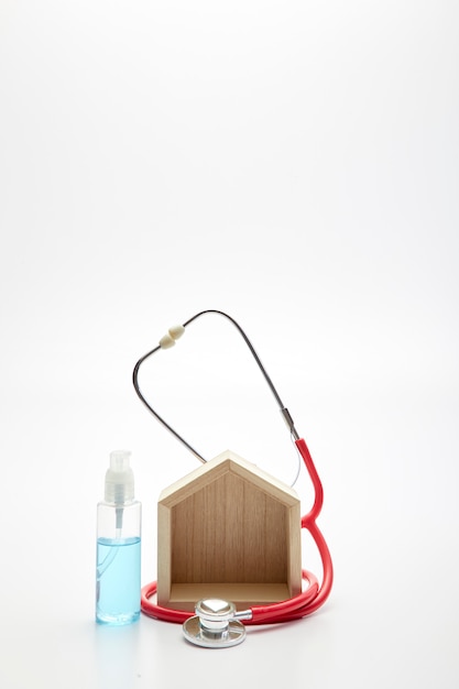 Medical concept, stethoscope, wooden home, and gel