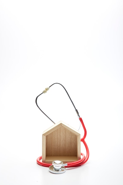 Medical concept, stethoscope and wooden home