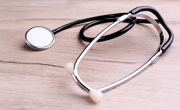 Medical concept - stethoscope on the wooden table