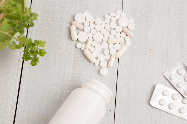 Medical concept white heart of pills and capsules