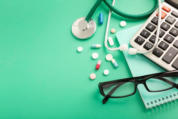 Medical concept with various medicines and calculator on blue background