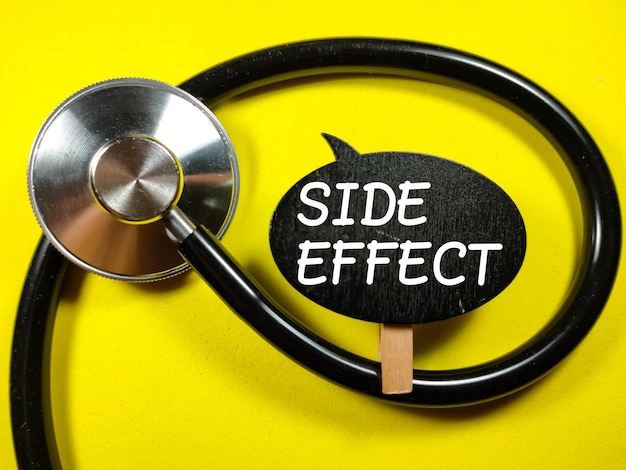 Medical conceptWord SIDE EFFECT with stethoscope on yellow background