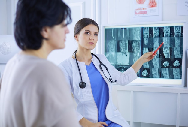 Medical consultation Female doctor holding a patient by her shoulder soothing her fear