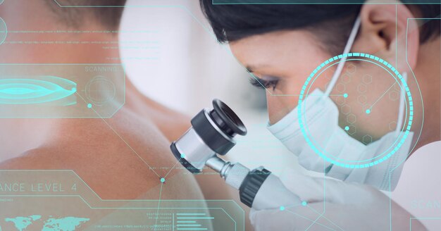 Medical data processing against female doctor wearing face mask examining back of male patient