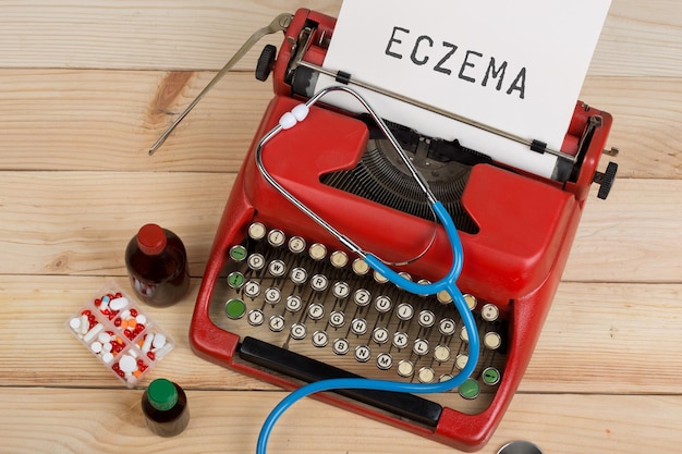 Medical diagnosis doctor workplace with blue stethoscope pills red typewriter with text Eczema