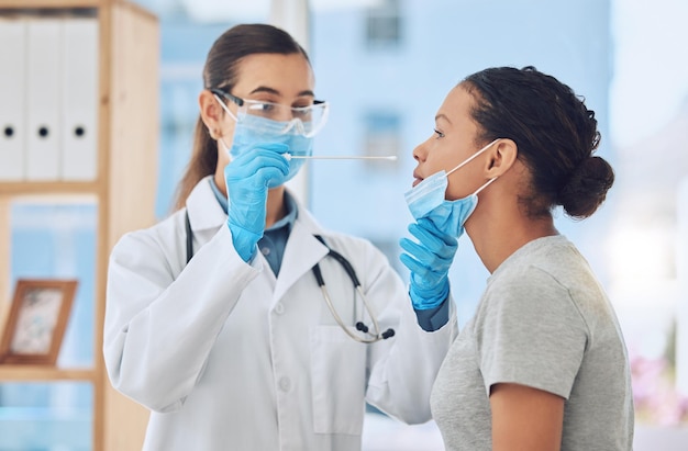 Medical doctor doing a covid test on patient by taking a sample with nose swab in her office Healthcare worker and woman with face mask in clinic consultation during coronavirus pandemic in hospital