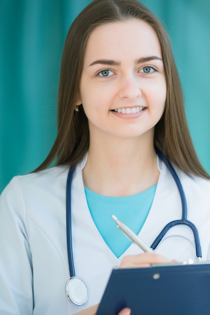 Medical doctor holding folder for notes in hands