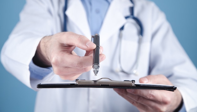 Medical doctor holding pen and clipboard.