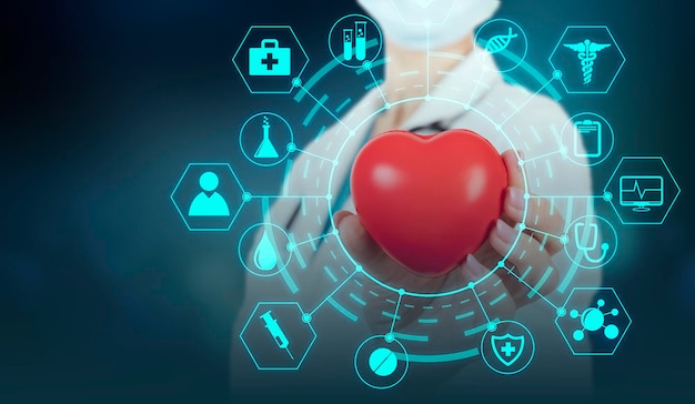 Medical doctor holding red heart shape and medical network icons. Copy space. High quality photo